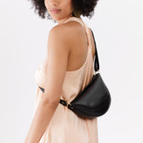 Pebbled--black Small | Model wearing petite half circle shaped sling bag