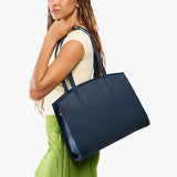 Deep Water Large | Model carrying leather tote bag with handles, adjustable crossbody strap, and two back pockets