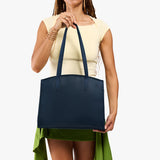 Deep Water Large | Model carrying leather tote bag with handles, adjustable crossbody strap, and two back pockets