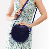 Cobalt Large | Model wearing circle shaped crossbody bag with top zipper