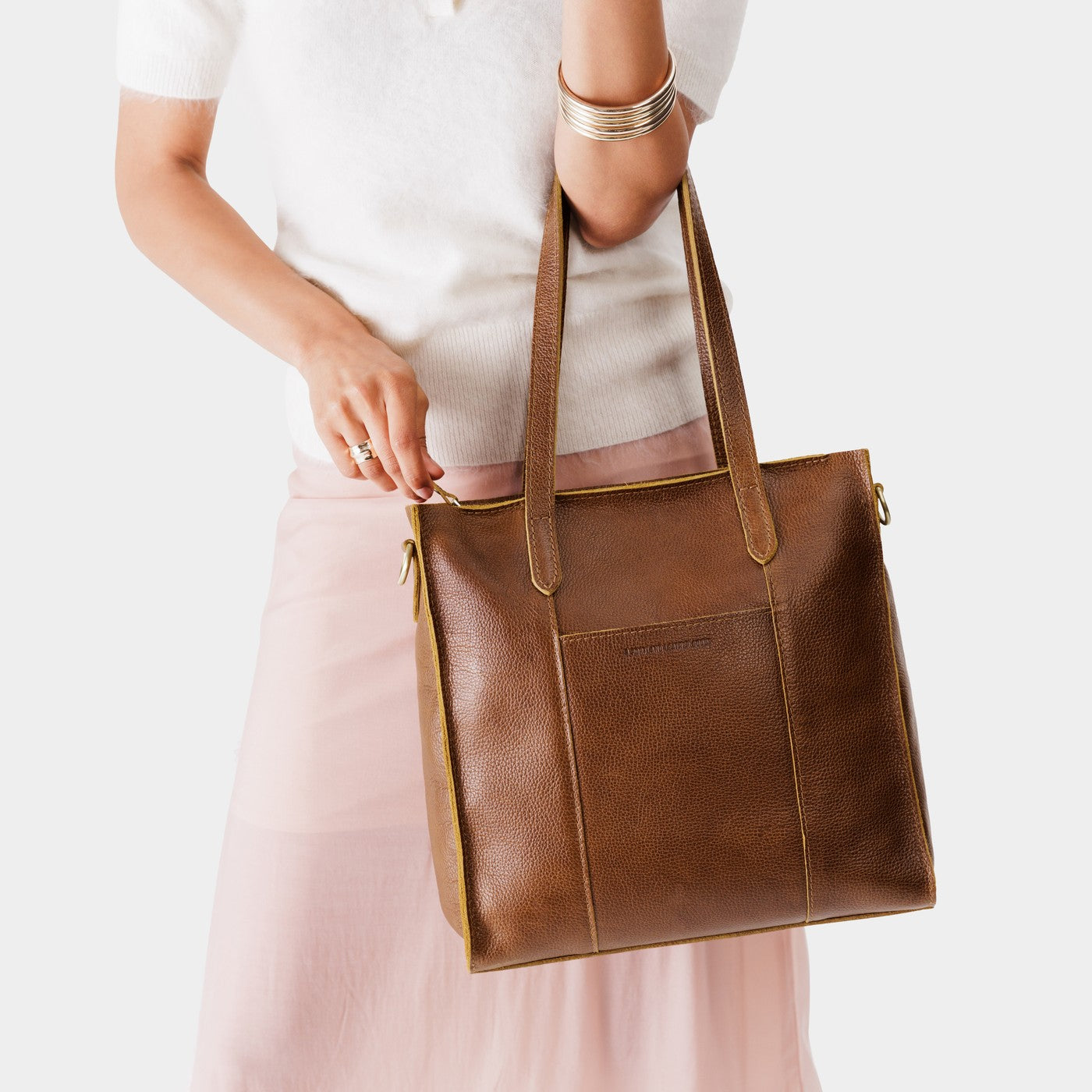 Asheville*North/South | Model wearing structured large tote bag with overlapping panels and crossbody strap