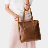 Asheville North/South | Model wearing structured large tote bag with overlapping panels and crossbody strap