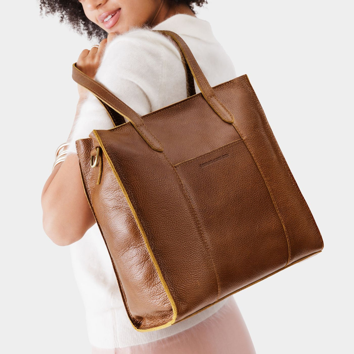 Asheville*North/South | Model wearing structured large tote bag with overlapping panels and crossbody strap
