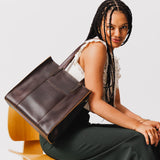 Grizzly North/South | Model wearing structured large tote bag with overlapping panels and crossbody strap