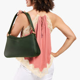 Evergreen Large | Model holding a bean shaped shoulder bag with a zipper closure