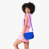 Blue Joy Large | Model wearing a leather Crossbody with a flap and magnetic closure