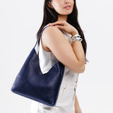 Cobalt Large | Model wearing mid-size shoulder bag with magnetic snap closure