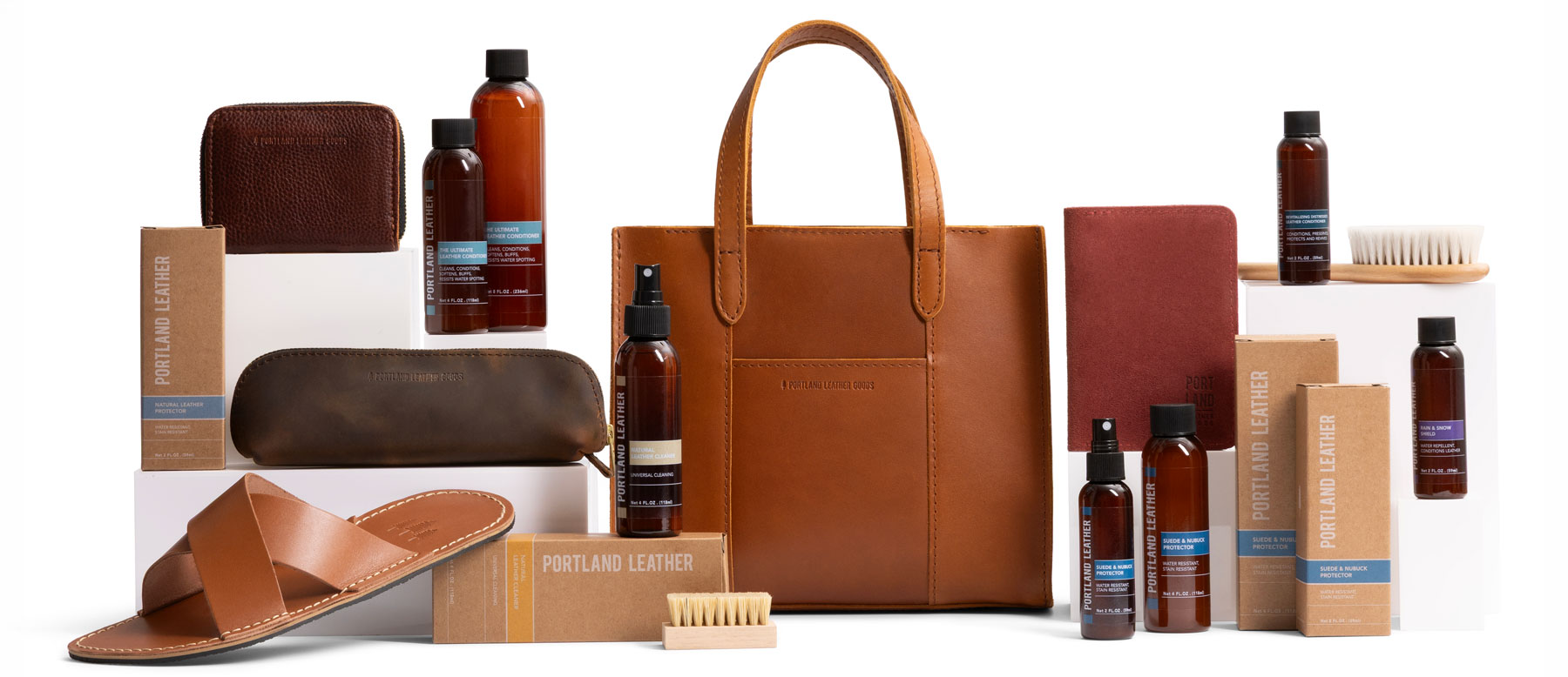 Bottles of leather care displayed with leather goods