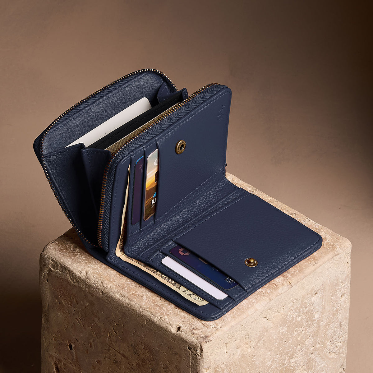 Anchor Blue | Open wallet with card and storage pockets on a light brown background