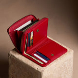 Icon Red | Open wallet with card and storage pockets on a light brown background