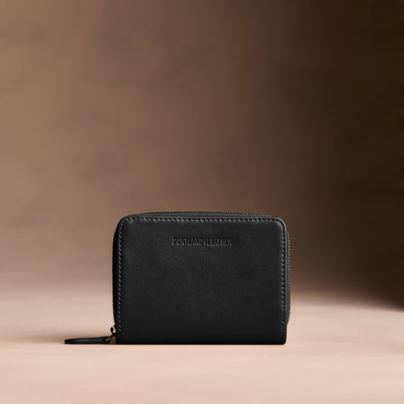 Onyx | Wallet with card and storage pockets on a light brown background