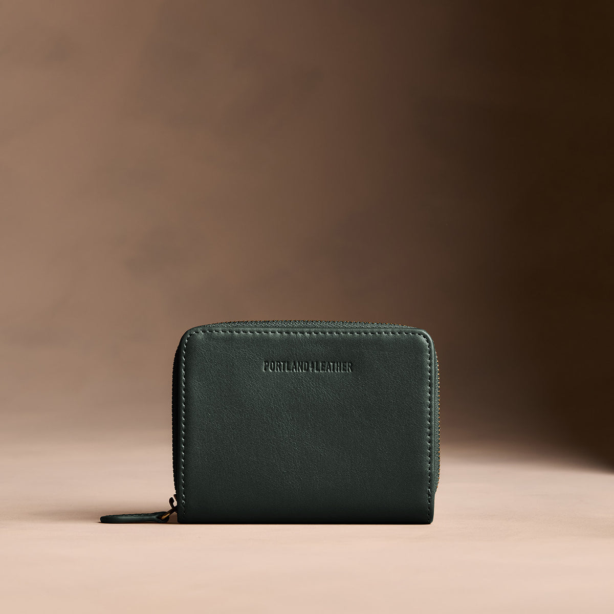 Regent Green | Wallet with card and storage pockets on a light brown background