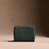 Regent Green | Wallet with card and storage pockets on a light brown background