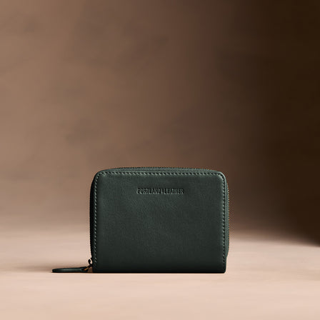 Regent Green | Wallet with card and storage pockets on a light brown background