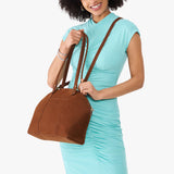 Wildwood Large | Model holding a half circle crossbody bag with handles and removable crossbody strap