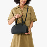Black Small | Model holding a half circle crossbody bag with handles and removable crossbody strap 