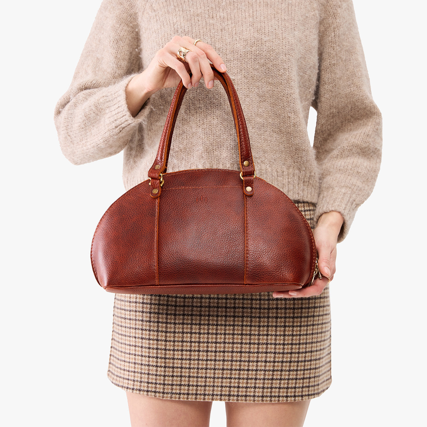 Nutmeg*Small | Model holding a half circle crossbody bag with handles and removable crossbody strap 