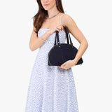 Velvet Blue Small | Model holding a half circle crossbody bag with handles and removable crossbody strap