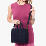 Velvet Blue | Model wearing structured mid-size tote bag with overlapping panels and crossbody strap