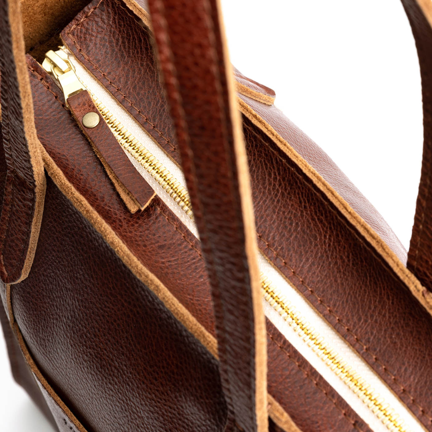 Nutmeg*North/South | Model holding structured large tote bag with overlapping panels and crossbody strap