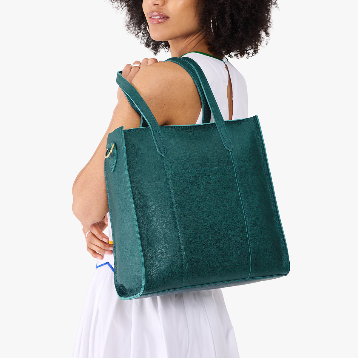 Sea Glass*North/South | Model wearing structured large tote bag with overlapping panels and crossbody strap