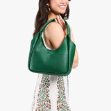Bacalar Medium | Model carrying U-shaped, flat-bottomed leather shoulder bag with two outside pockets