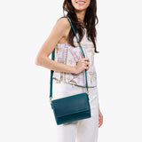 Westward Blue Medium | Model Wearing Small Leather Crossbody Bag with Magnetic Messenger Bag Closure