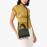 Evergreen Mini | Model carrying small leather tote bag with handles, adjustable crossbody strap, and one back pocket