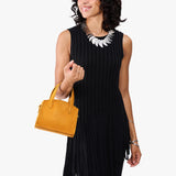 Sunshine Mini | Model carrying small leather tote bag with handles, adjustable crossbody strap, and one back pocket