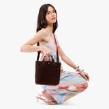 Velvet Brown Classic | Model carrying crossbody tote bag with snap closure and front pocket