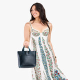 Boreal Classic | Model holding crossbody tote bag with snap closure and front pocket