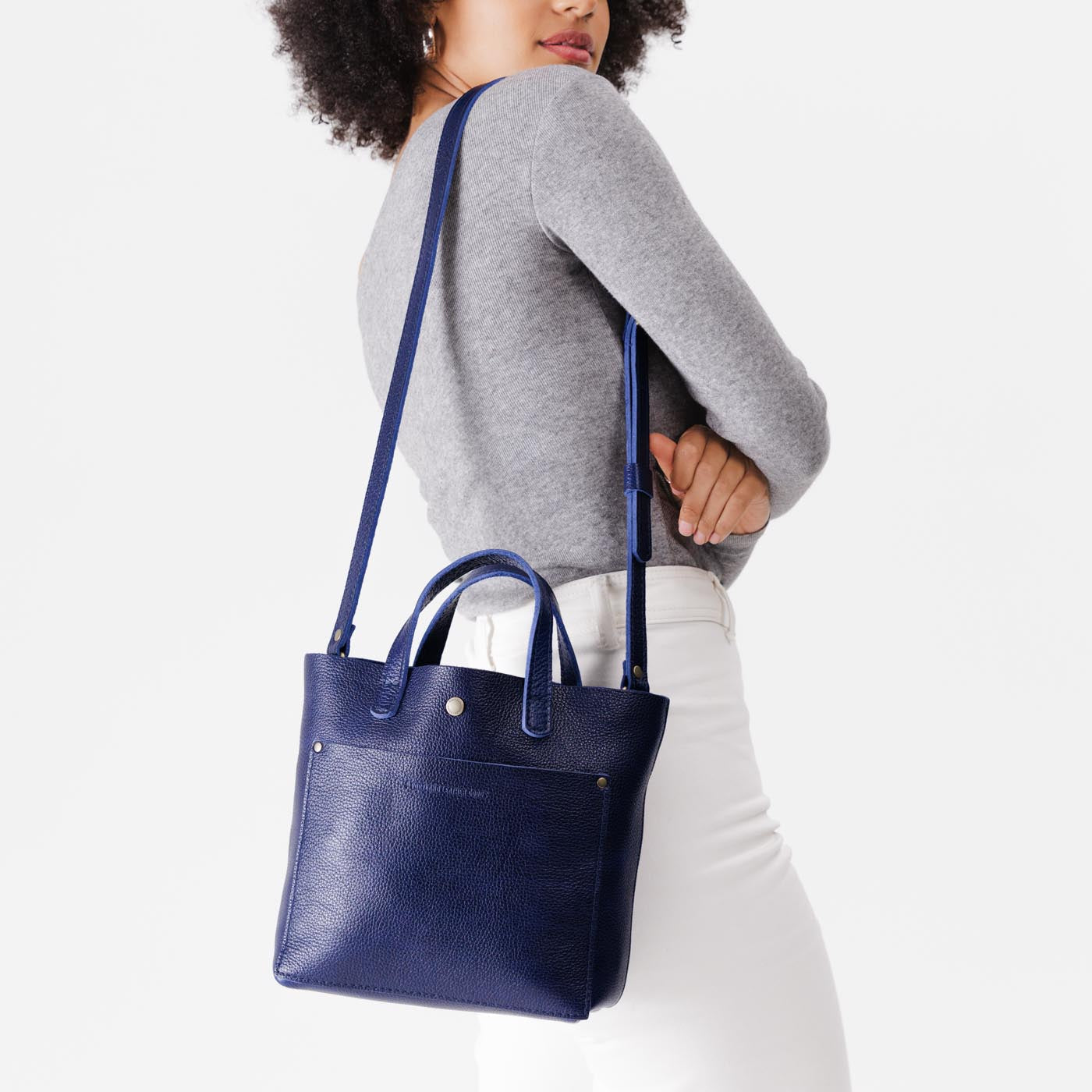 Cobalt*Classic | Model wearing crossbody tote bag with snap closure and front pocket