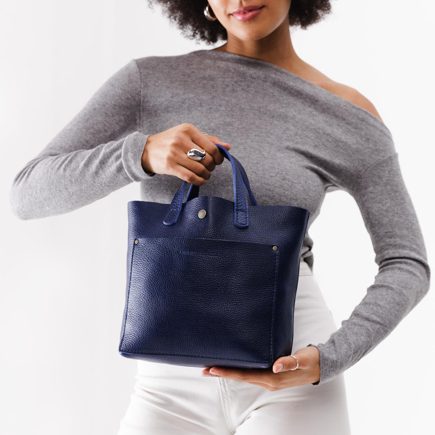 Cobalt*Classic | Model holding crossbody tote bag with snap closure and front pocket