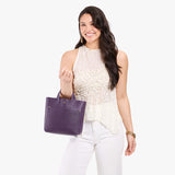 Empire Classic | Model carrying crossbody tote bag with snap closure and front pocket