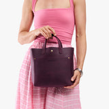 Larkspur Classic | Model carrying crossbody tote bag with snap closure and front pocket