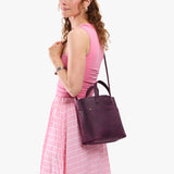 Larkspur Classic | Model carrying crossbody tote bag with snap closure and front pocket