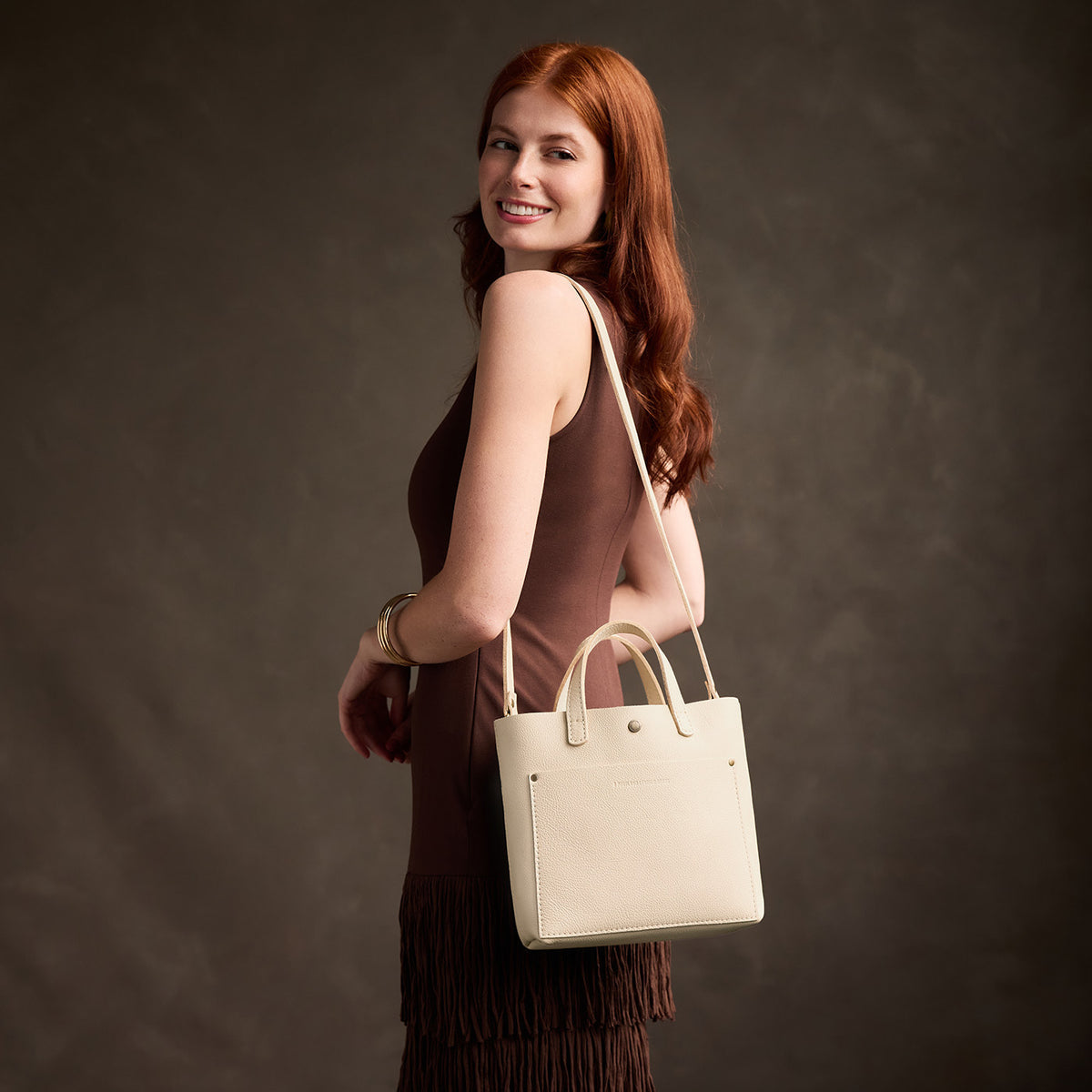 Pebbled Bone*Classic | Model carrying crossbody tote bag with snap closure and front pocket