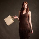 Pebbled Bone Classic | Model carrying crossbody tote bag with snap closure and front pocket