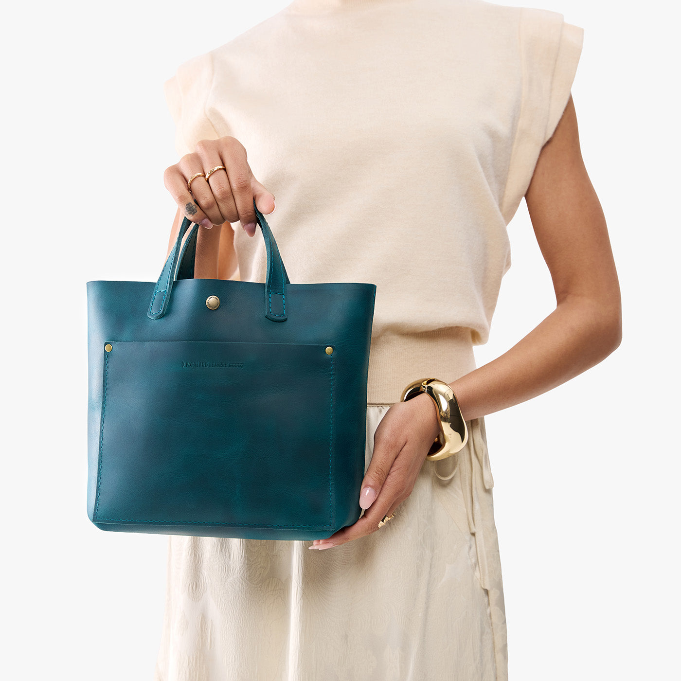 Westward Blue*Classic | Model holding crossbody tote bag with snap closure and front pocket