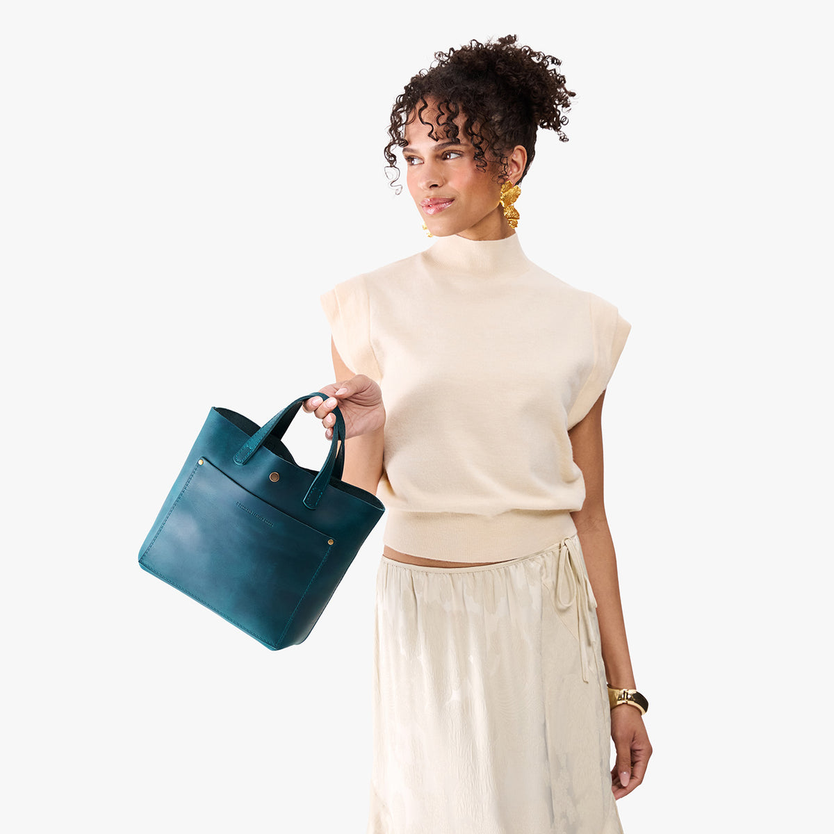 Westward Blue*Classic | Model holding crossbody tote bag with snap closure and front pocket