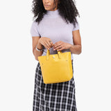 Pomello Classic | Model wearing crossbody tote bag with snap closure and front pocket