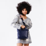 Cobalt Zipper | Model wearing crossbody tote bag with snap closure and front pocket
