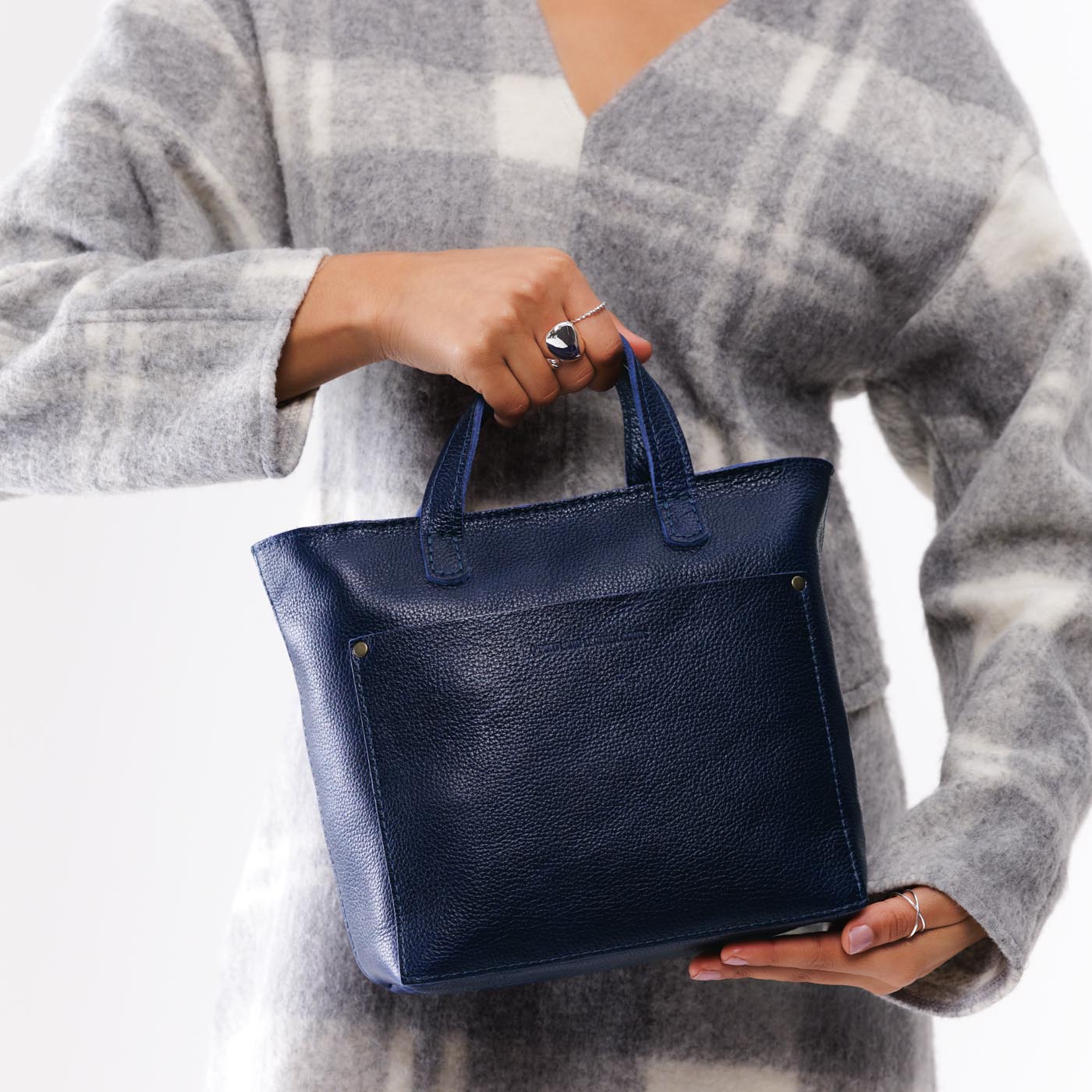 Cobalt*Zipper | Model holding crossbody tote bag with zipper closure and front pocket