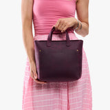 Larkspur Zipper | Model carrying crossbody tote bag with snap closure and front pocket