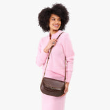 Chocolate Brown Large | Model wearing a leather Crossbody with a flap and magnetic closure