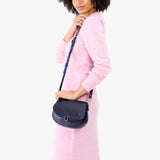 Cobalt Small | Model wearing a petite leather Crossbody with a flap and magnetic closure