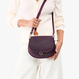 Larkspur Small | Model wearing a petite leather Crossbody with a flap and magnetic closure