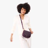 Larkspur Small | Model wearing a petite leather Crossbody with a flap and magnetic closure