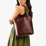 Cognac Medium Classic | Model wearing leather tote bag with riveted straps and exterior key loop