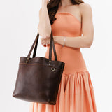 Coldbrew Medium Classic | Model wearing leather tote bag with riveted straps and exterior key loop
